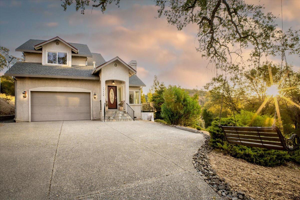 a front view of a house with a yard and garage