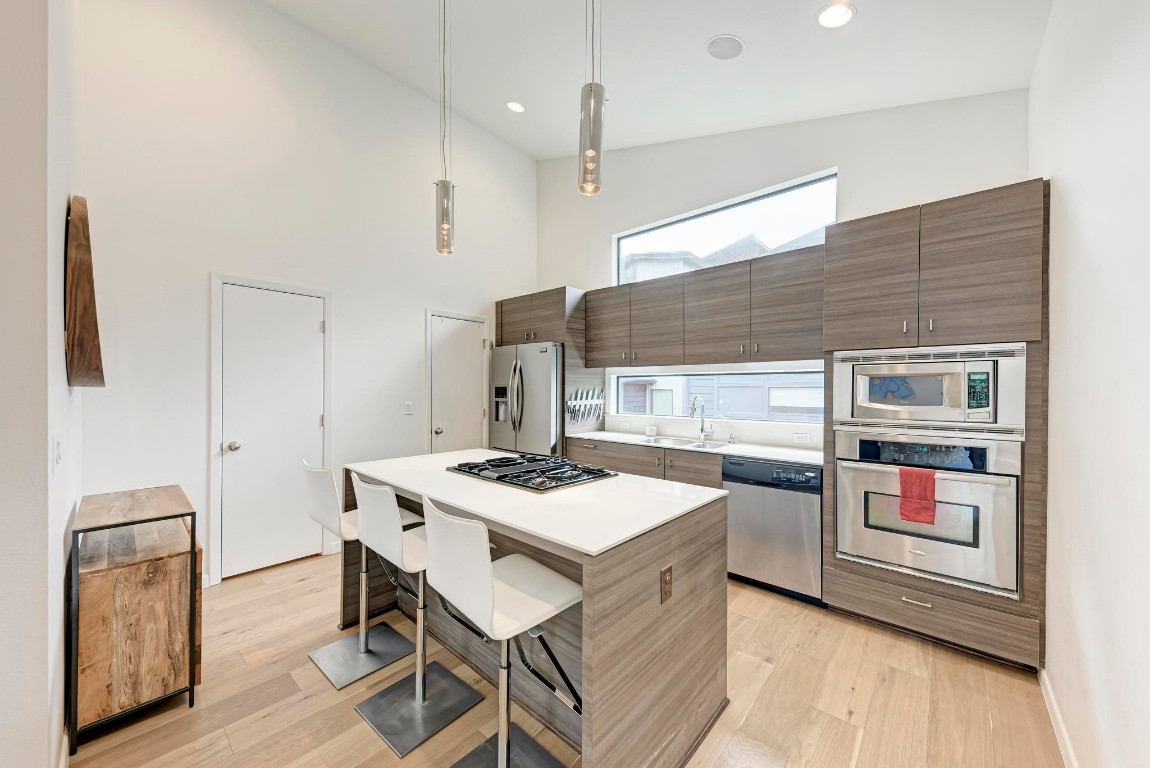 a kitchen with a stove a refrigerator and a stove top oven