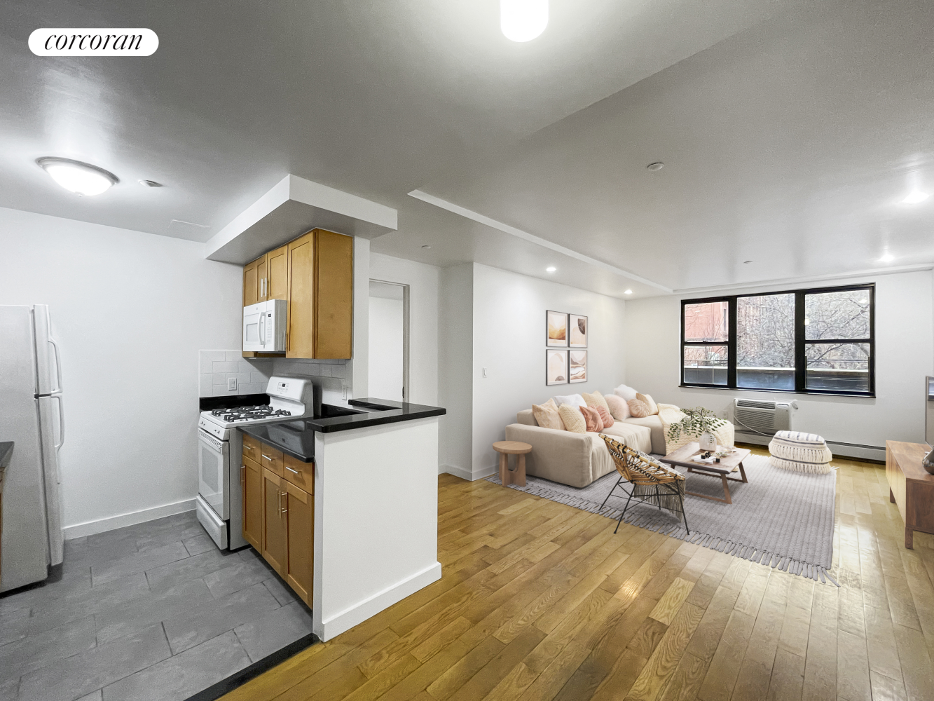 a living room with stainless steel appliances granite countertop furniture and a wooden floor