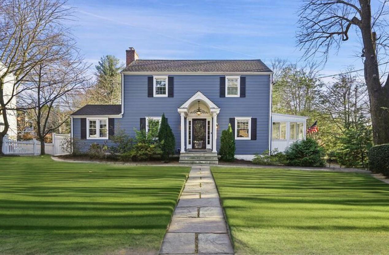 Colonial home featuring a front yard