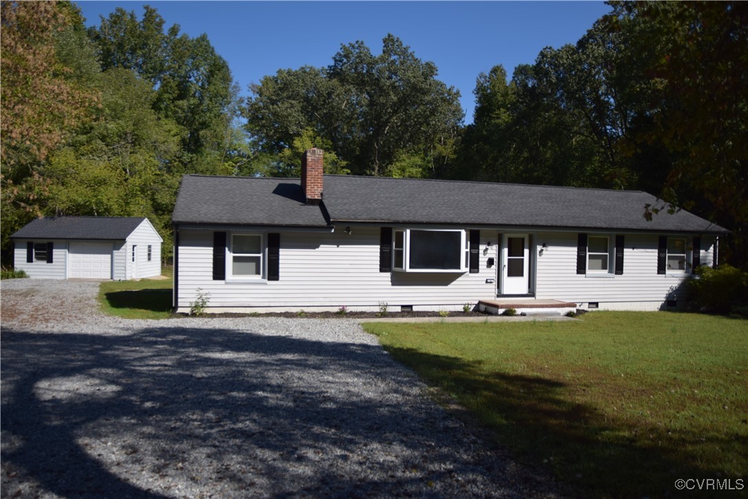 Single story home featuring a front lawn and an ou