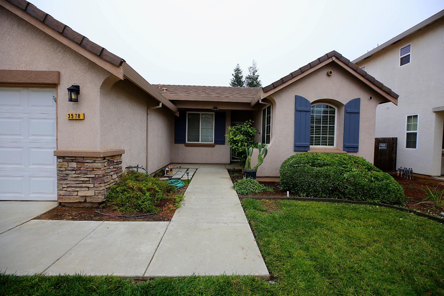 a front view of a house with garden