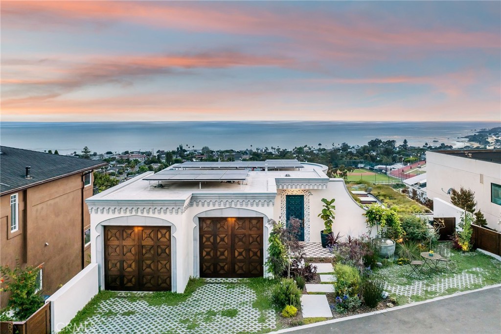 an aerial view of a house with a yard and balcony