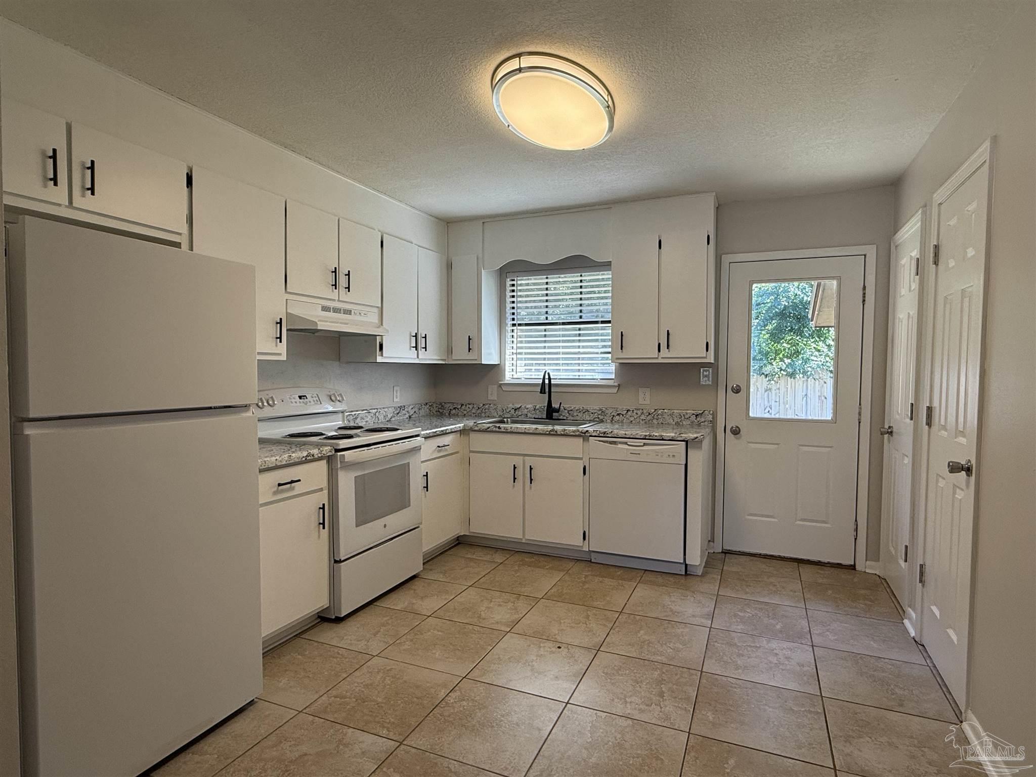 a kitchen with a white cabinets and white appliances