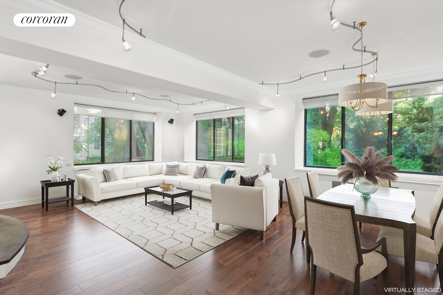 a living room with furniture large window and wooden floor