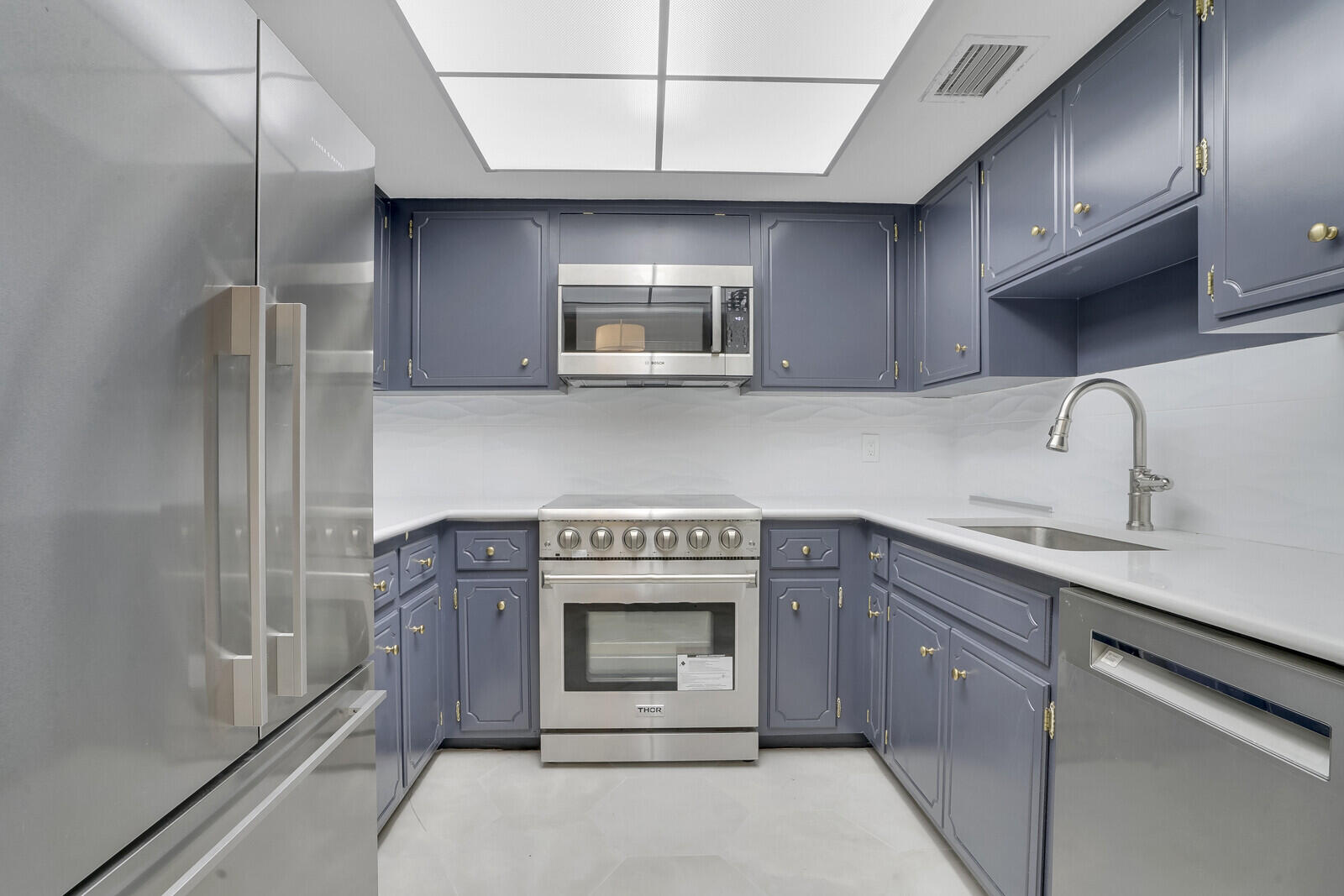 a kitchen with stainless steel appliances granite countertop a stove and a sink