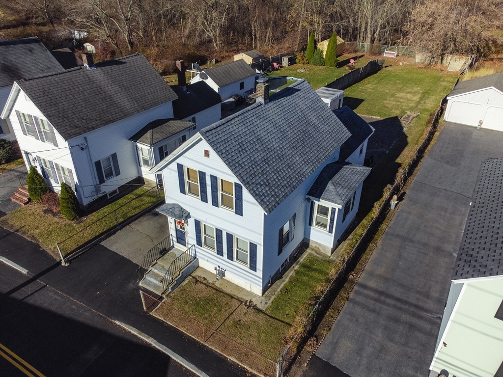 an aerial view of a house with outdoor seating