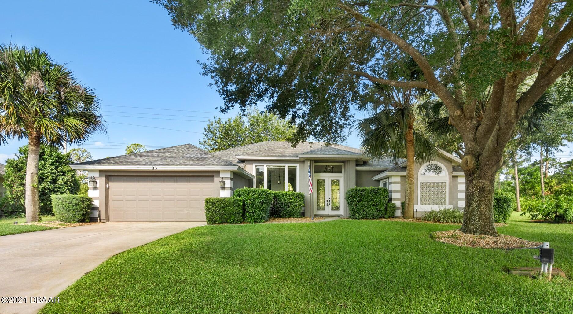 a front view of a house with a garden