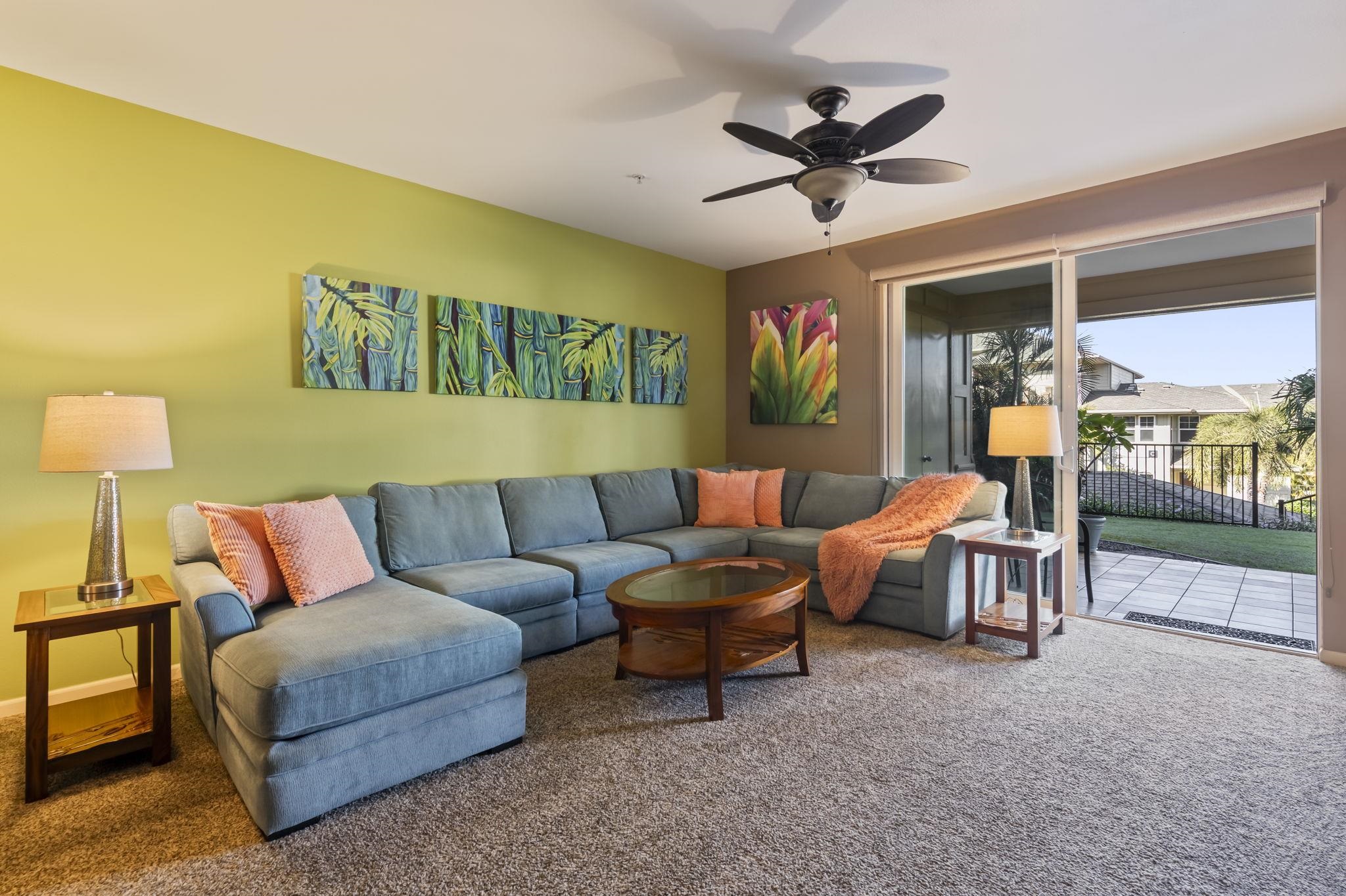 a living room with furniture and a ceiling fan