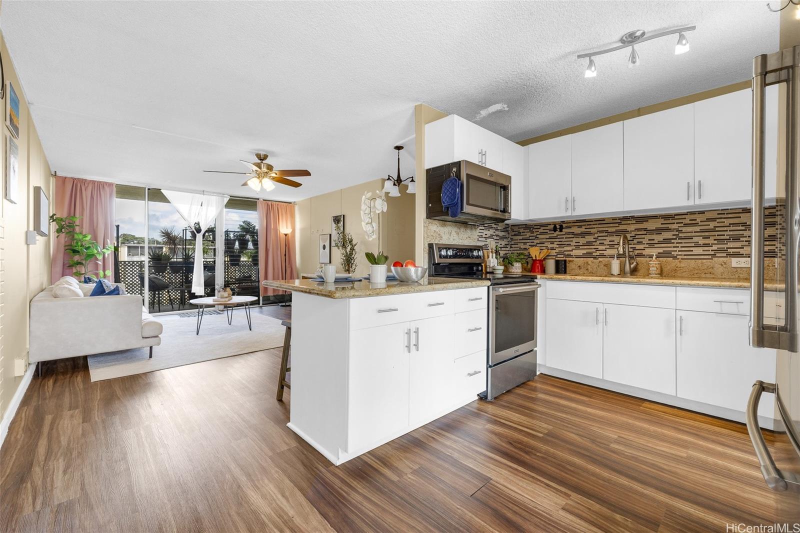 a kitchen with stainless steel appliances sink stove top oven and cabinets