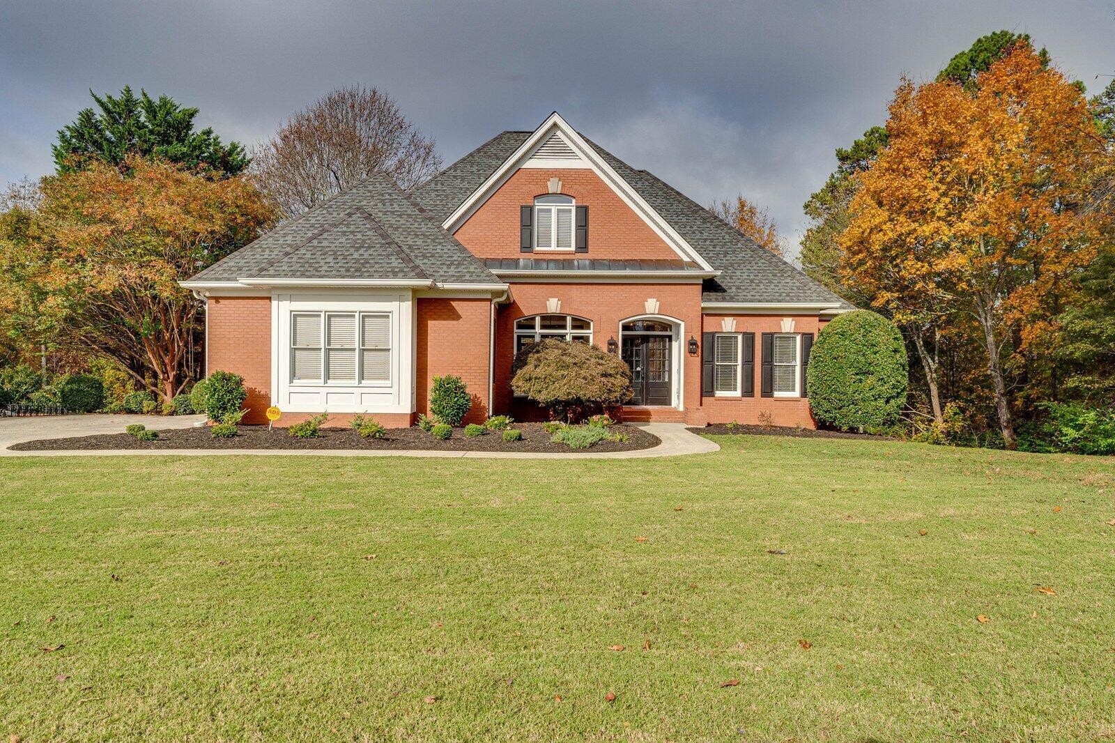 a front view of a house with a garden and porch