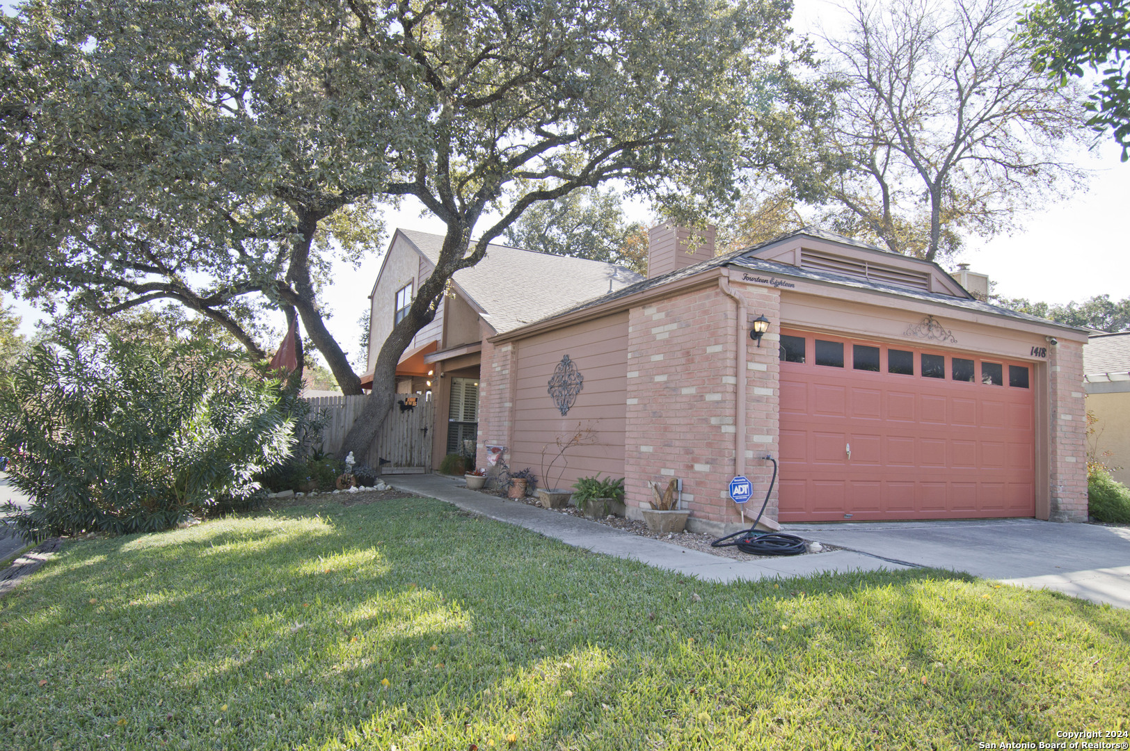 a view of backyard of house with green space