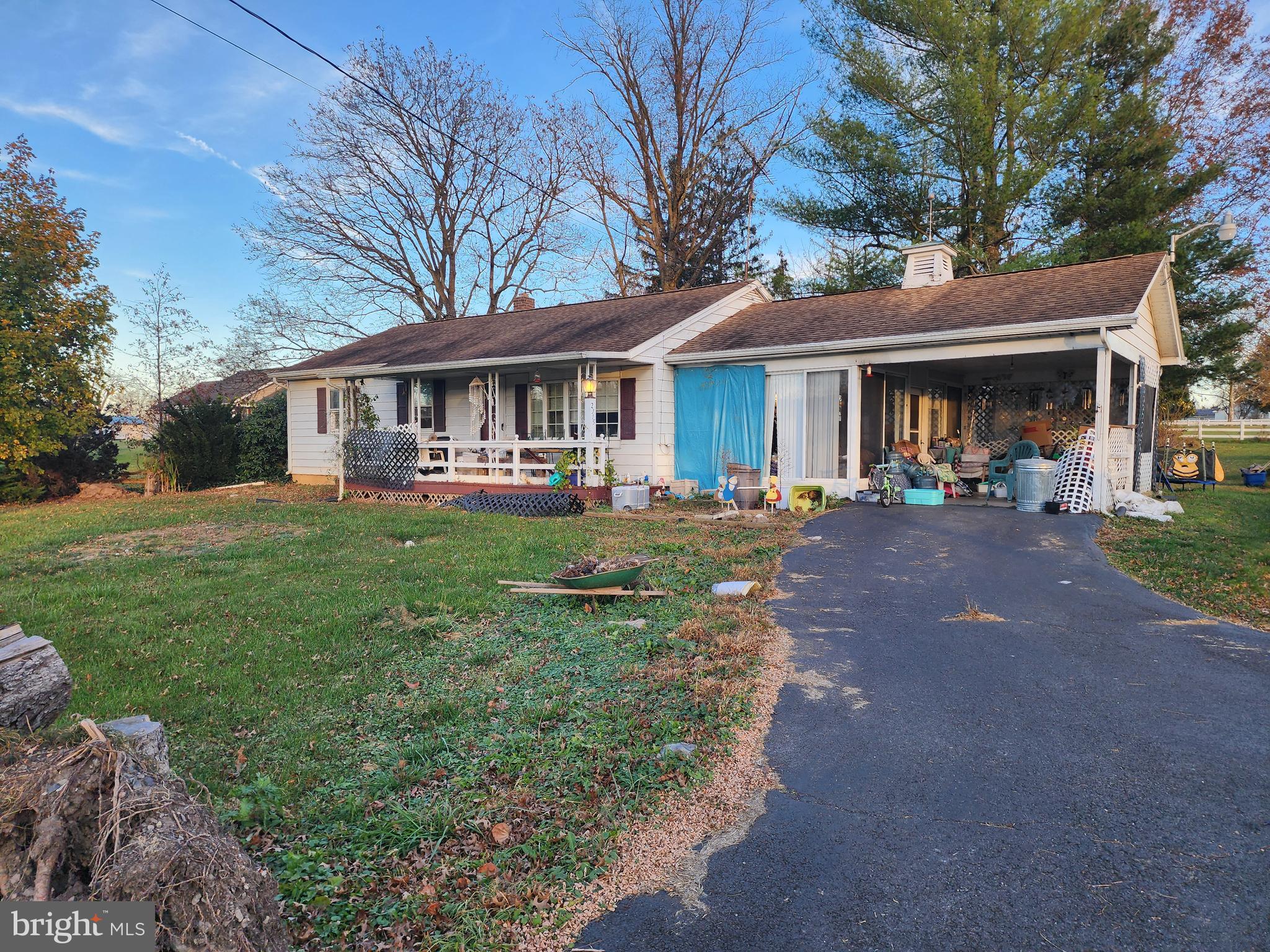 a front view of a house with a yard and trees