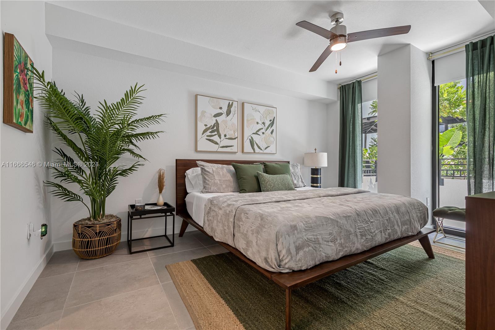 a bedroom with a large bed and a potted plant