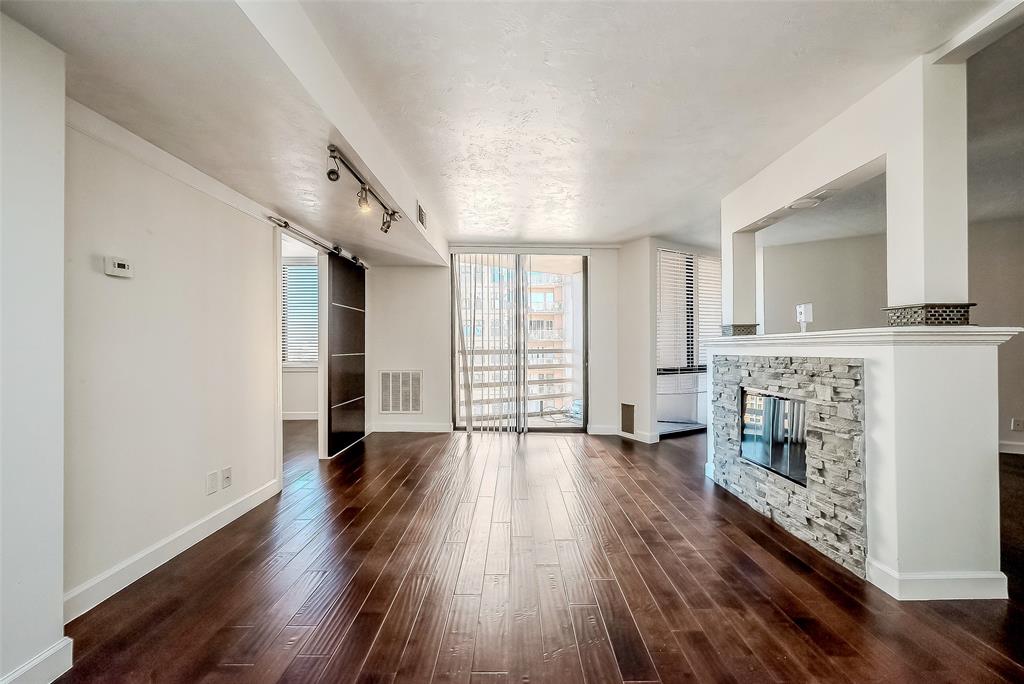 a view of a room with wooden floor and fireplace