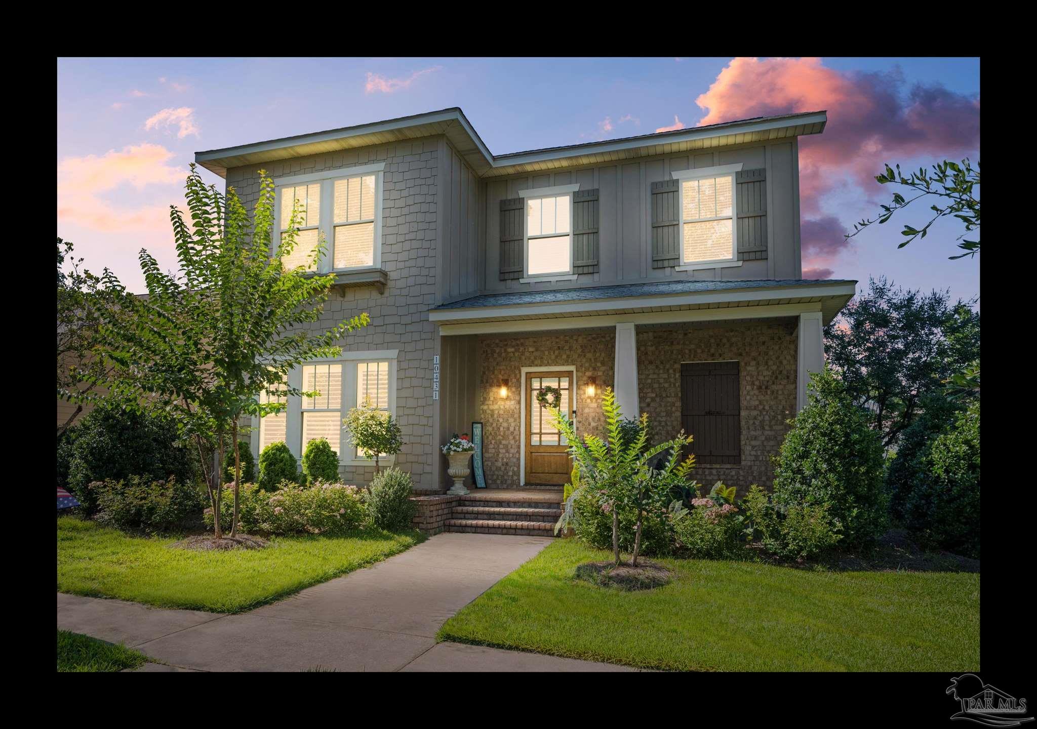 a front view of a house with garden