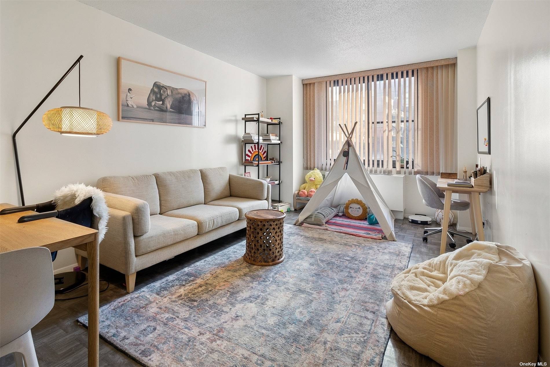 a living room with furniture a rug and white walls