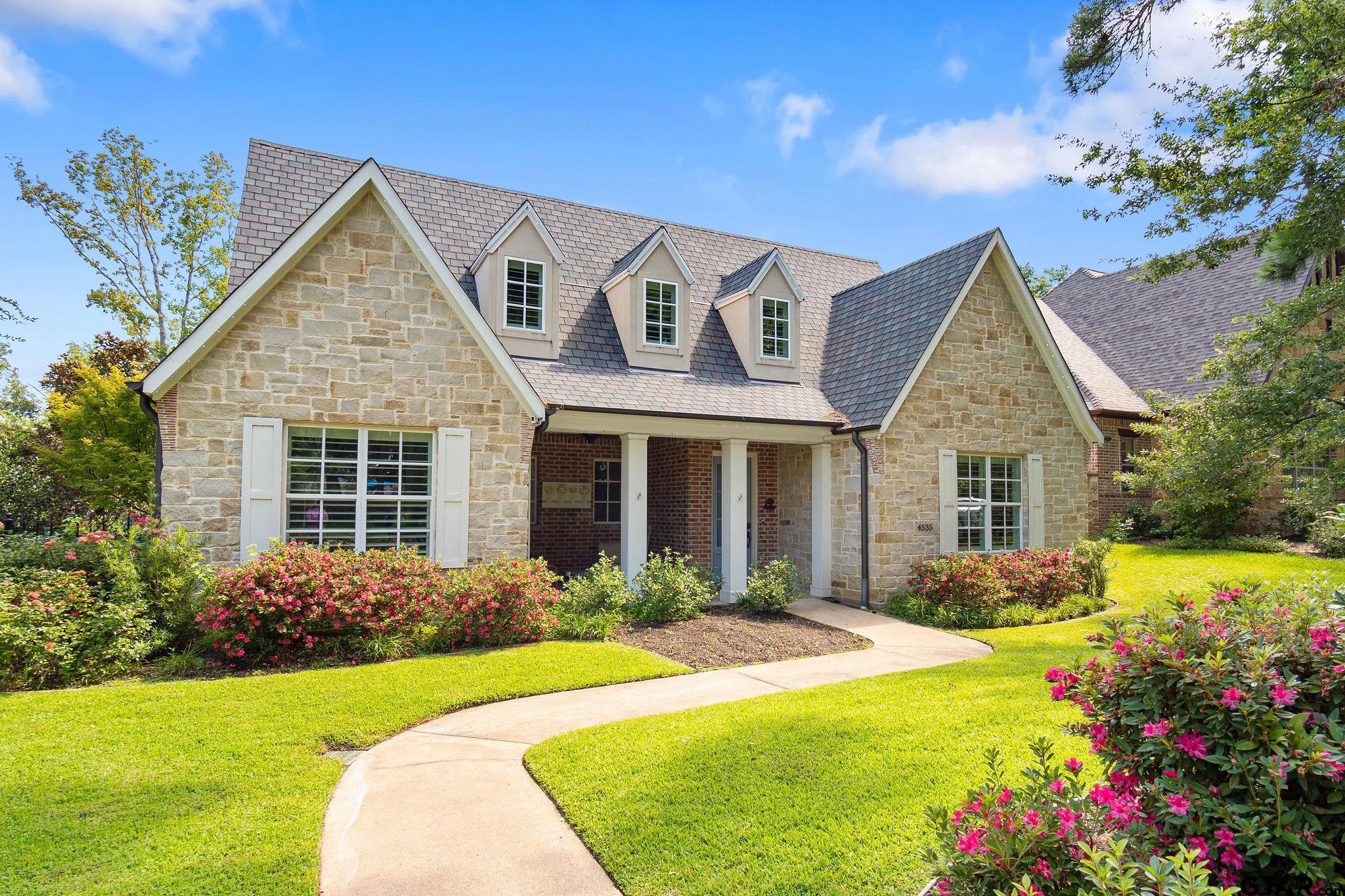 a front view of a house with garden