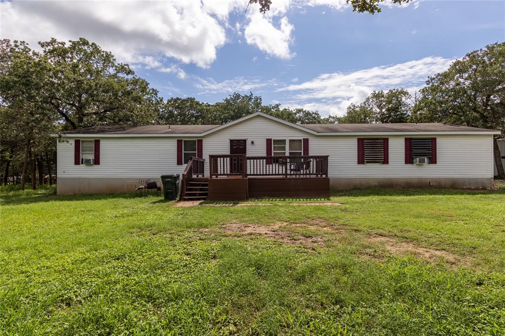 a view of a house with a backyard