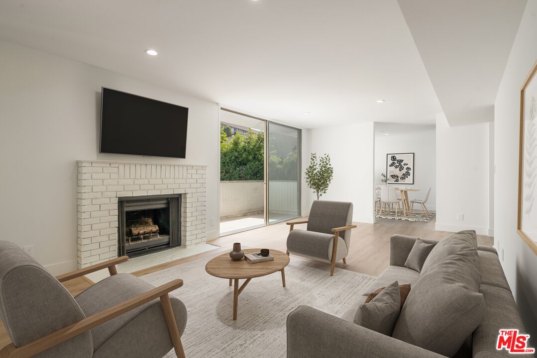 a living room with furniture fireplace and a flat screen tv