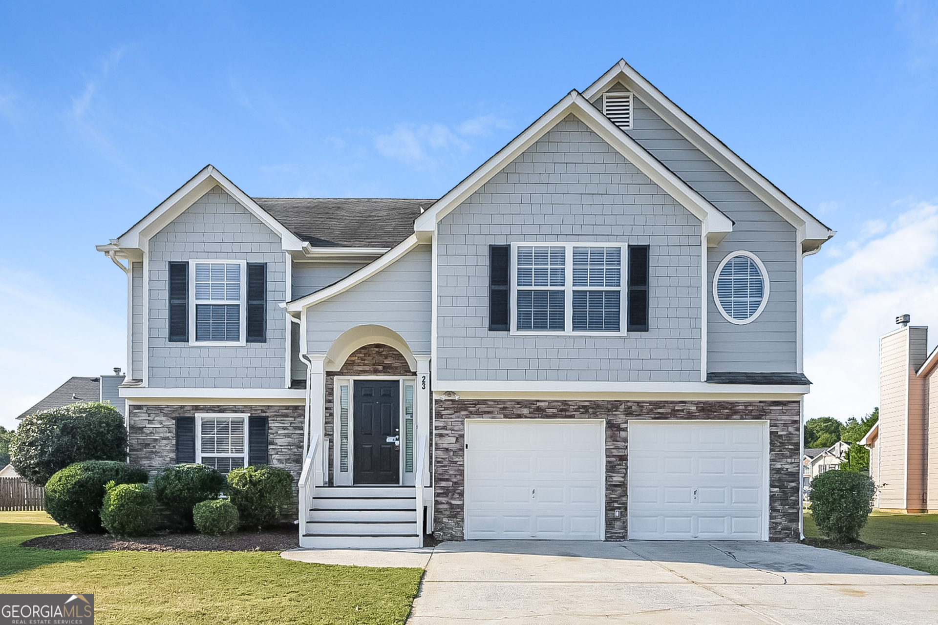 a front view of a house with garage