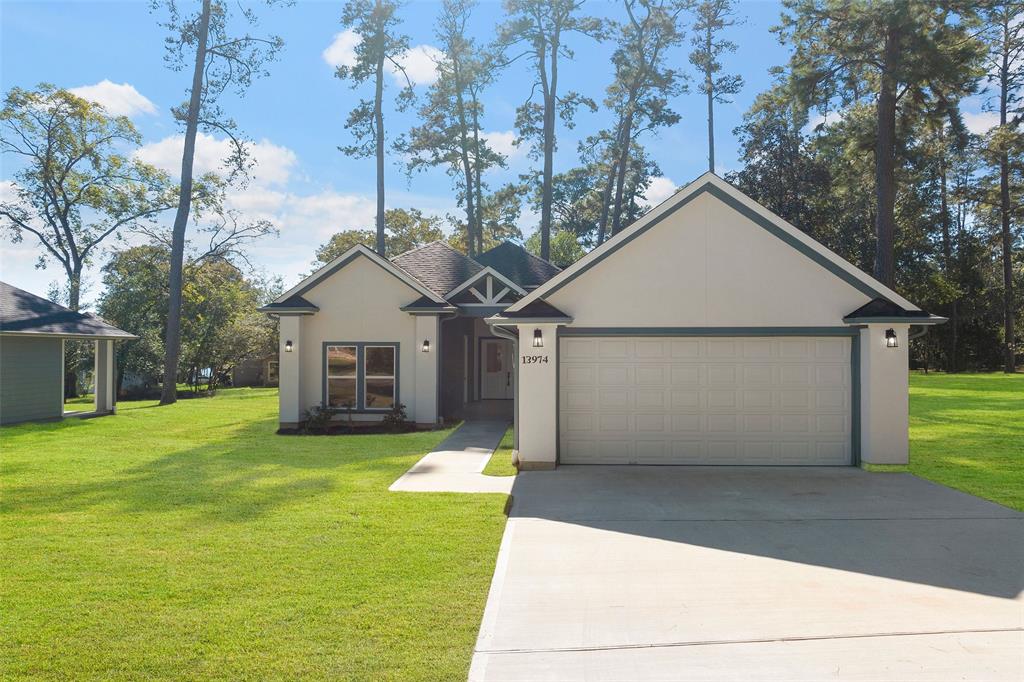 a view of a house with a yard and garage