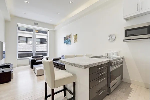 a kitchen with stainless steel appliances granite countertop a stove and a refrigerator