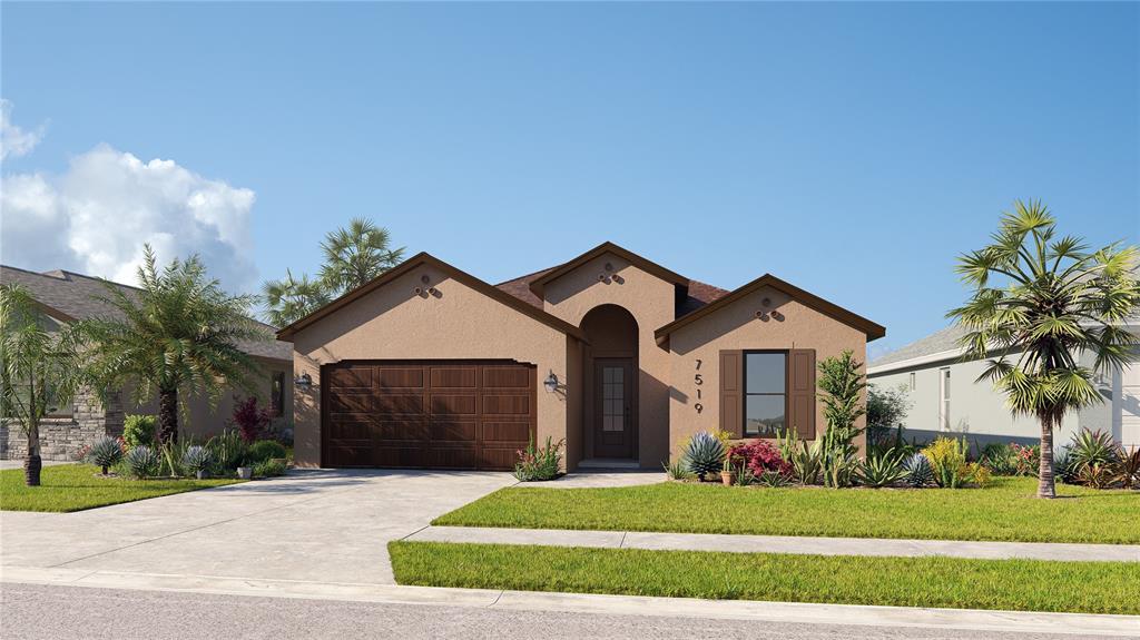 a front view of a house with a yard and garage