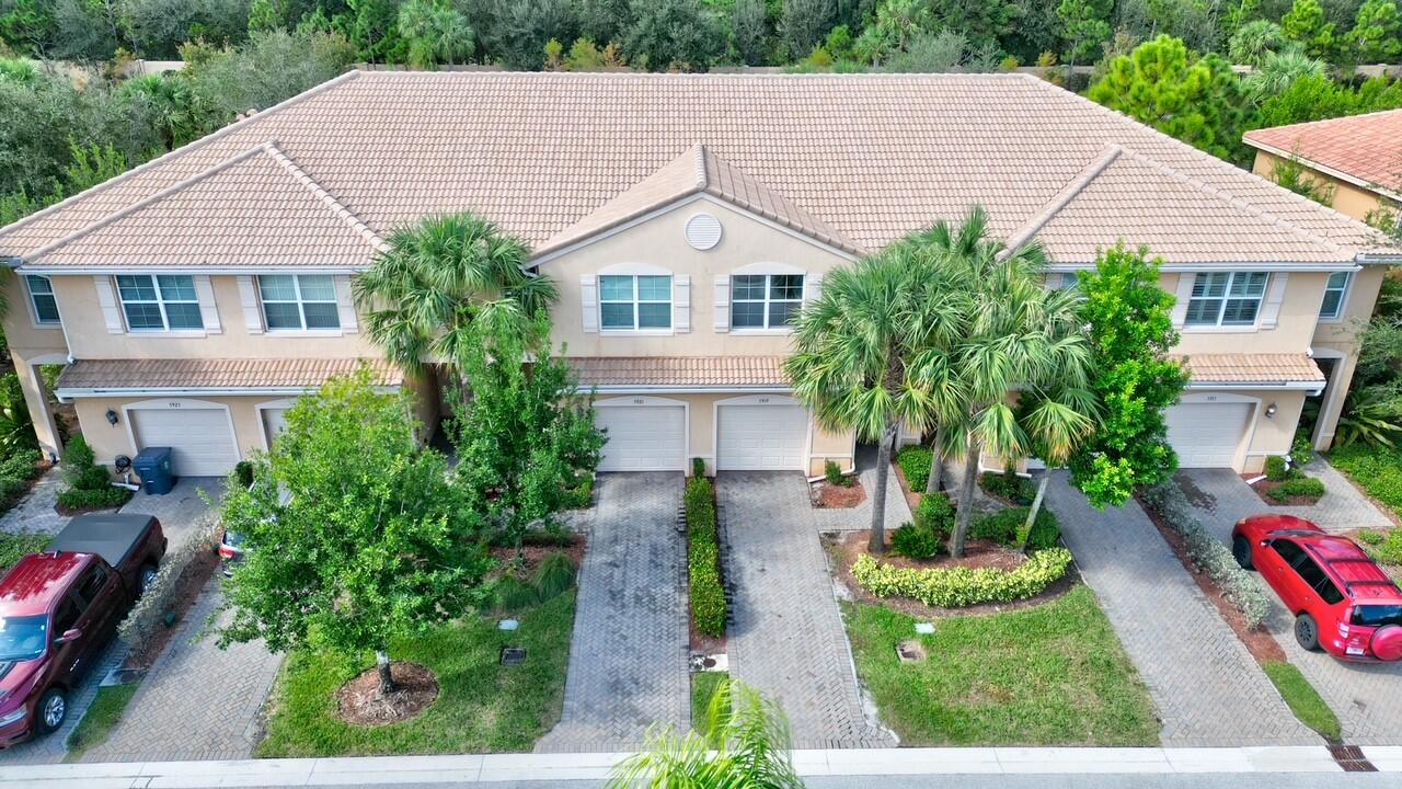 a aerial view of a house with a yard and potted plants