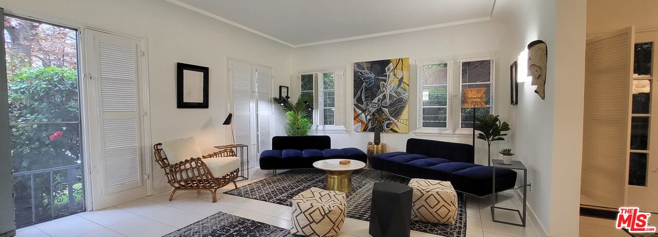 a living room with furniture and a potted plant