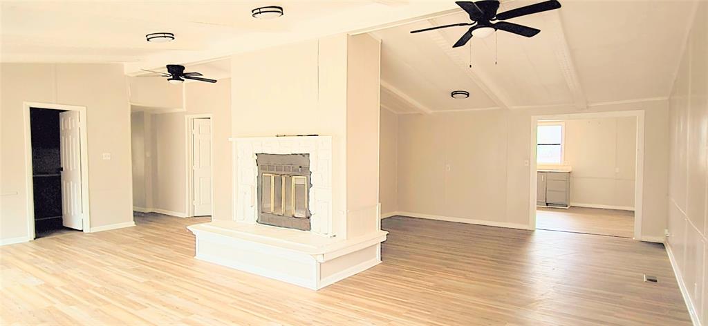 a view of a room with wooden floor and white walls