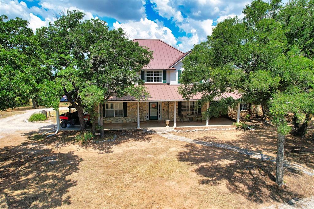 a view of a house with backyard and sitting area