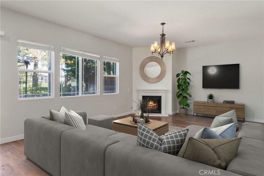 a living room with furniture a fireplace and a flat screen tv