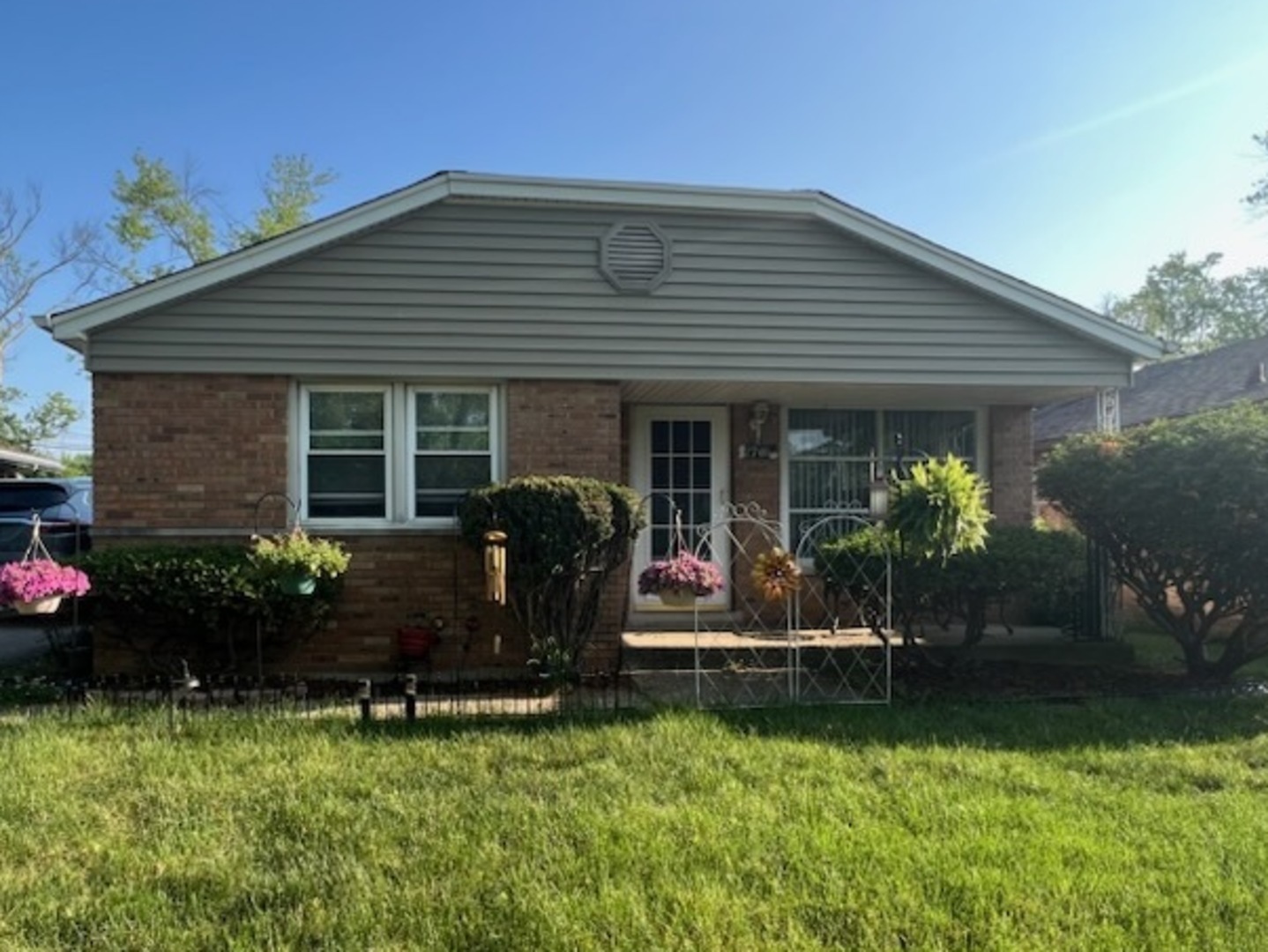 a front view of house with a garden