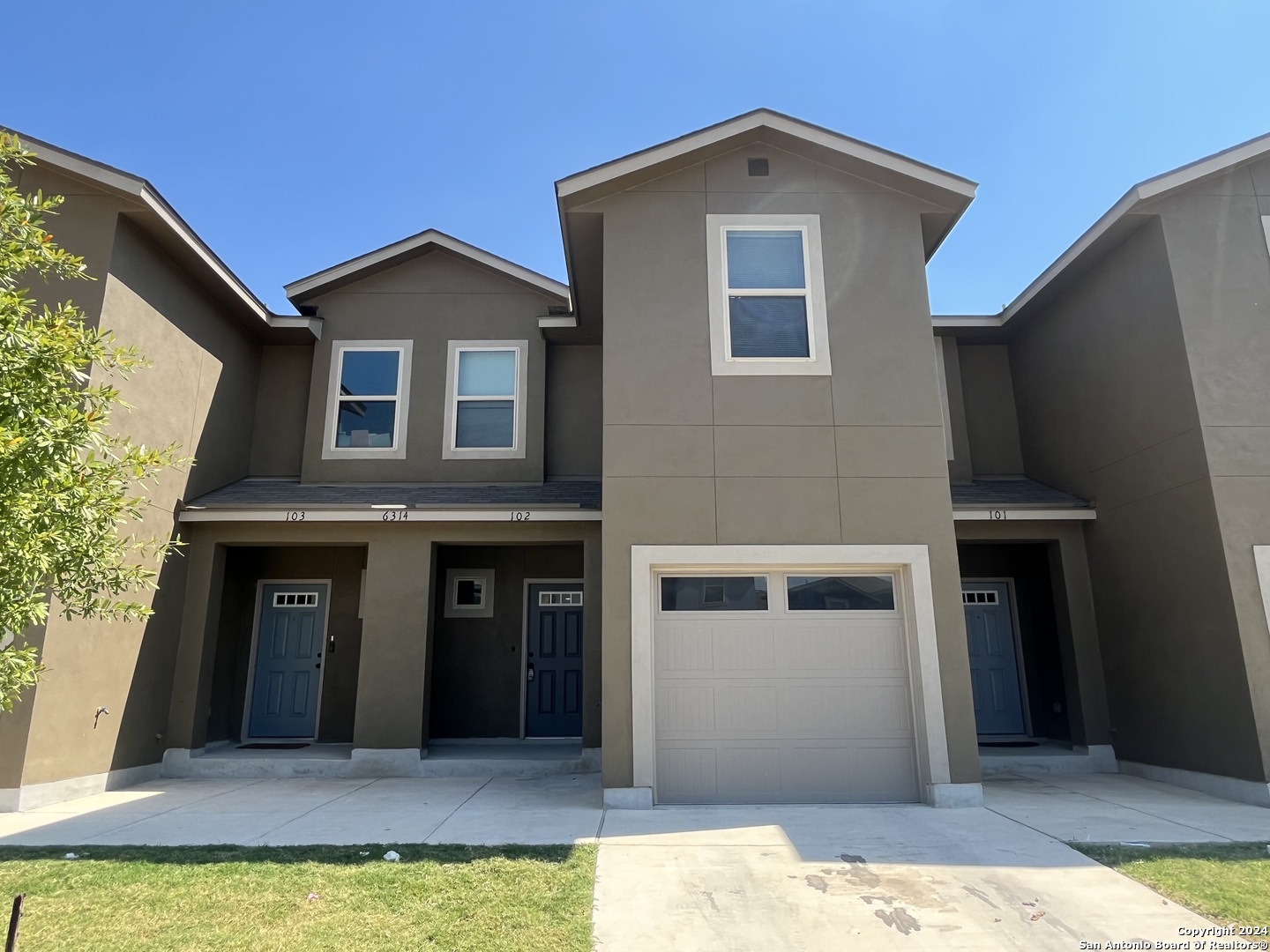 a front view of a house with a yard