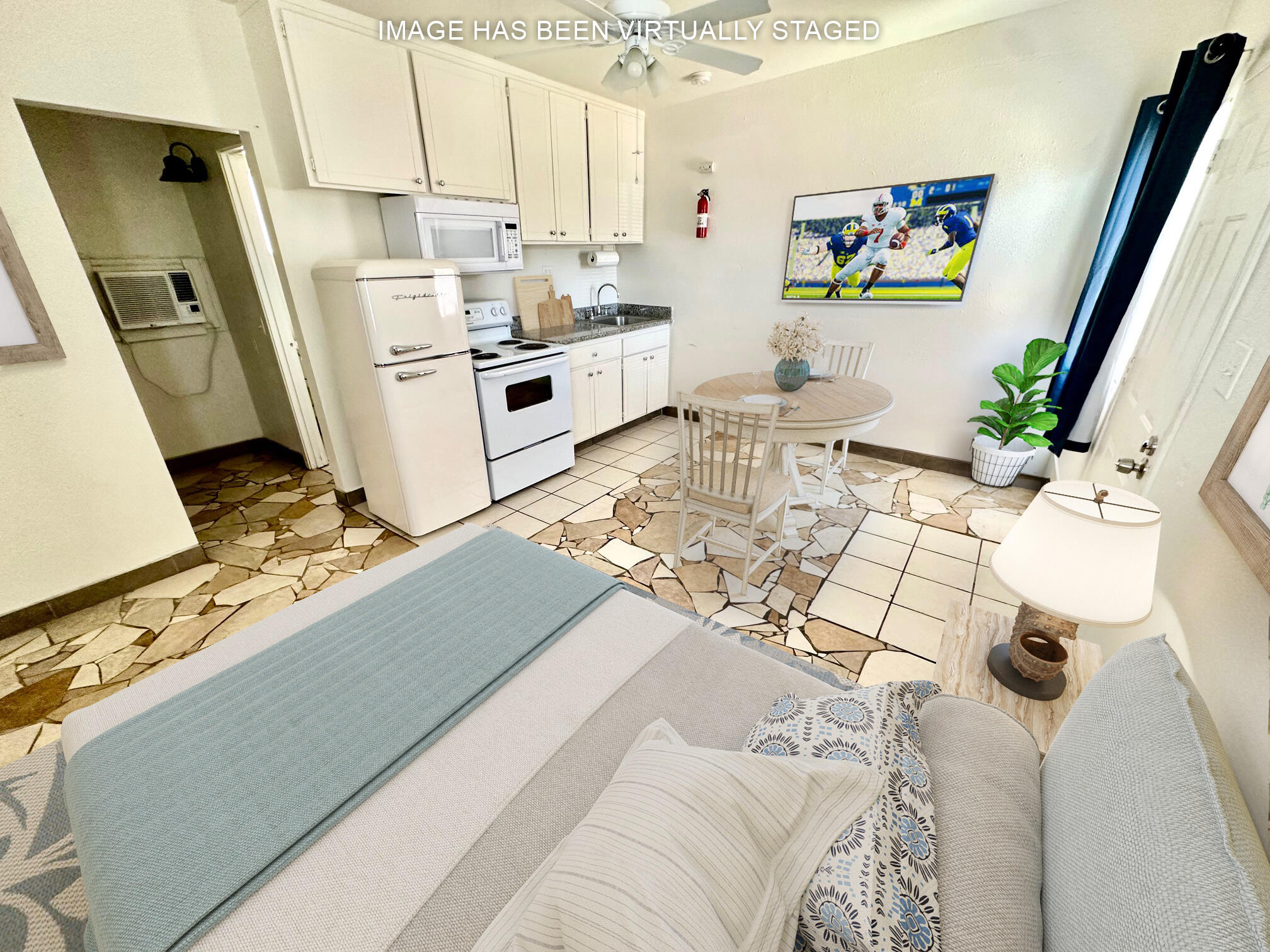 a living room with stainless steel appliances furniture a rug and a view of kitchen