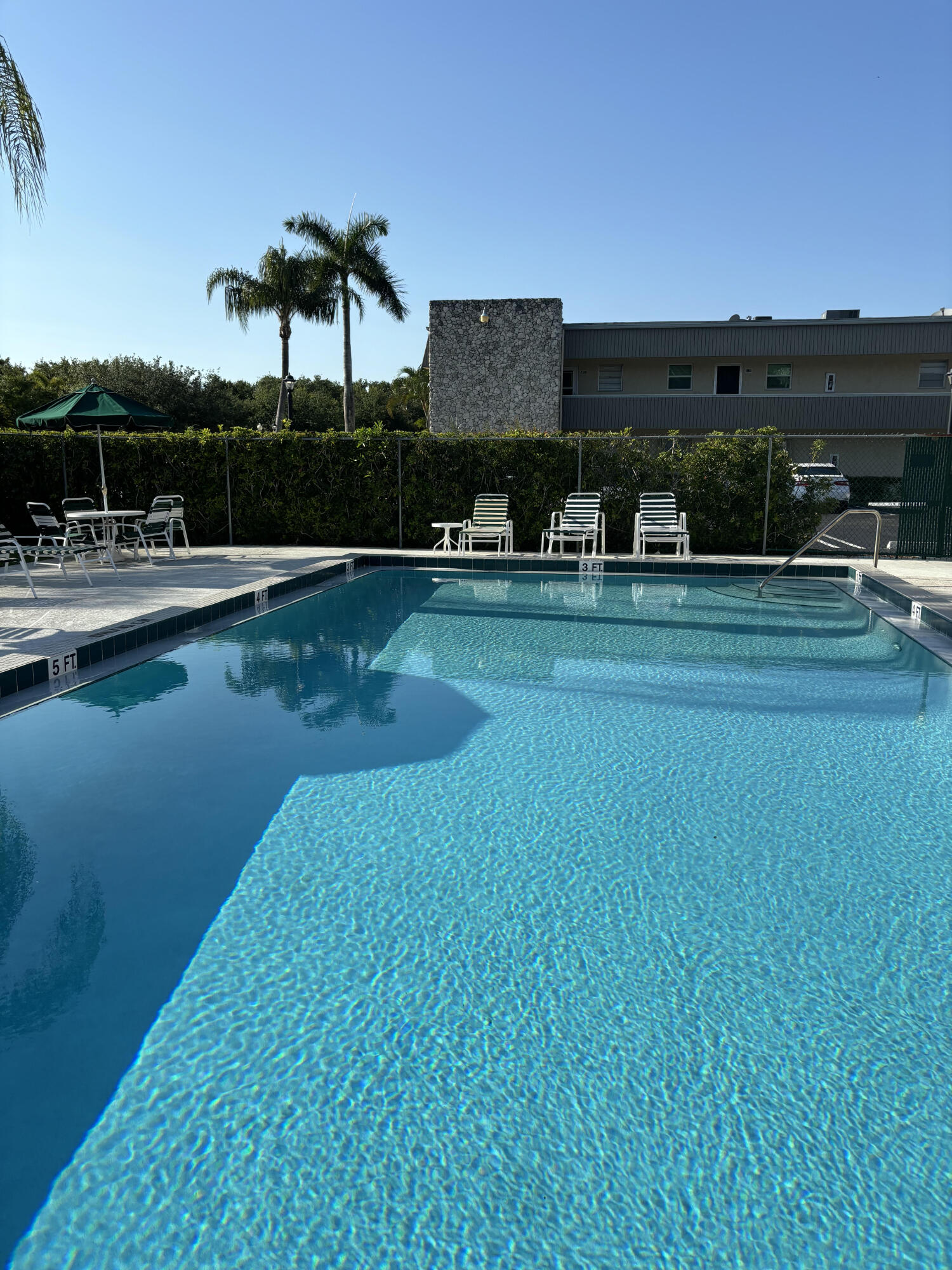 a view of a swimming pool with a table and chairs