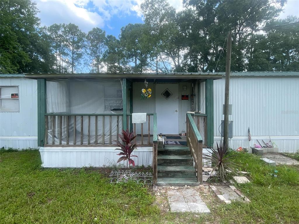 a view of a wooden deck and a yard