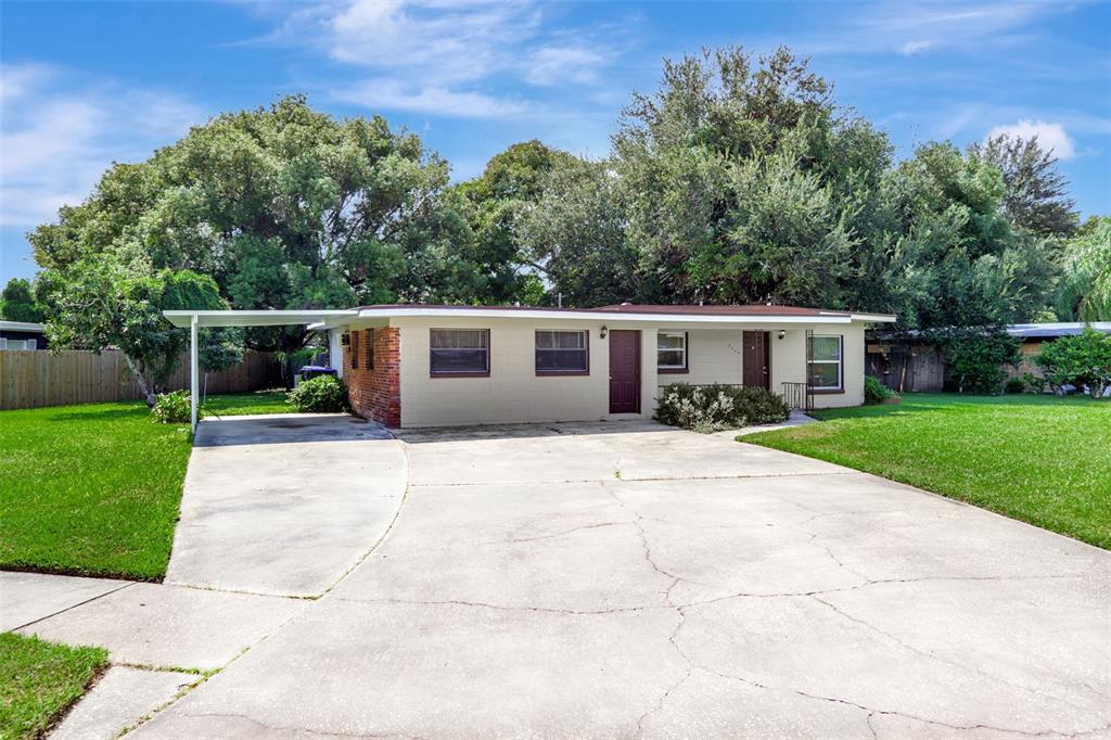 a front view of house with yard and green space