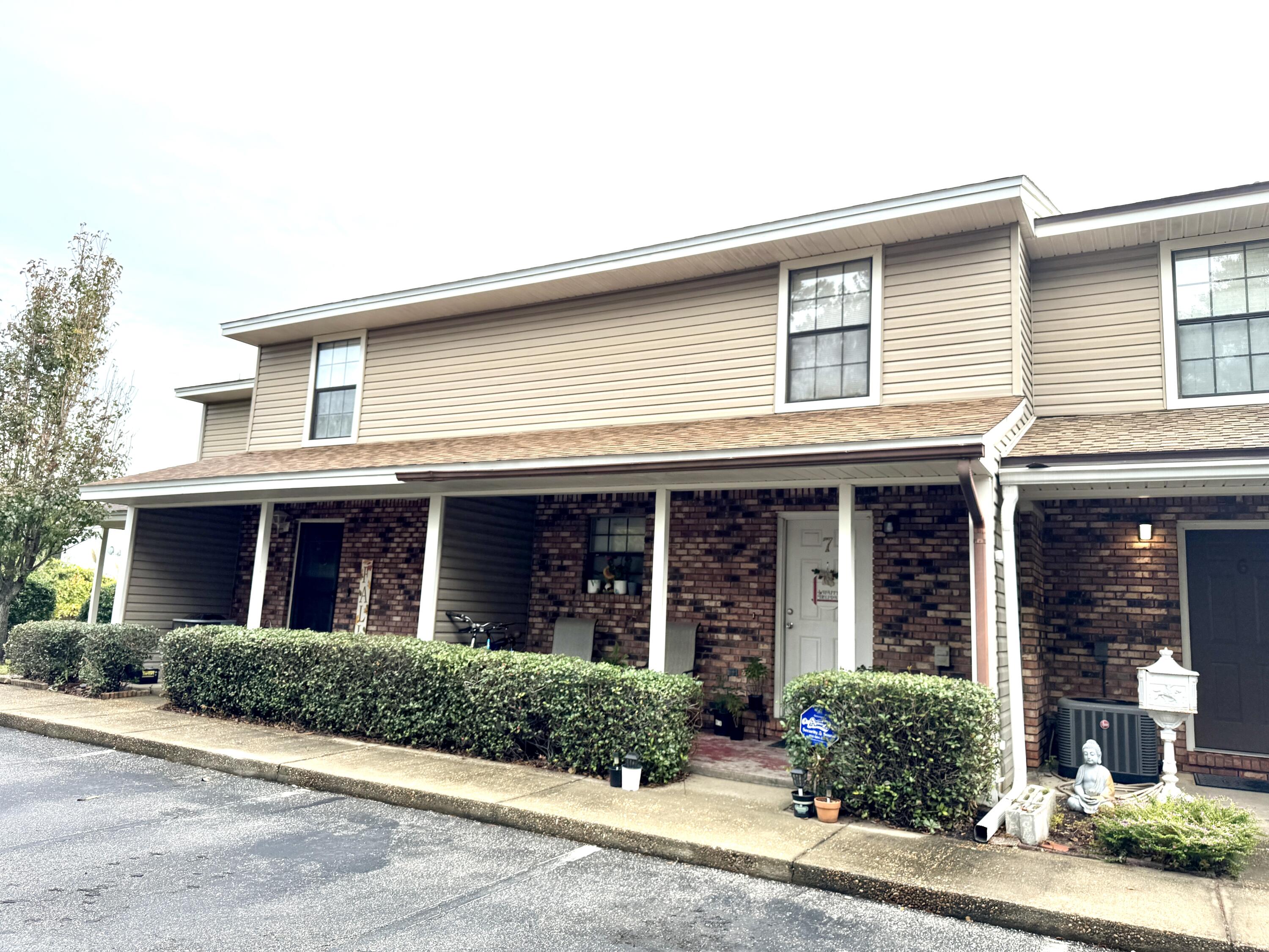 front view of brick house with a yard