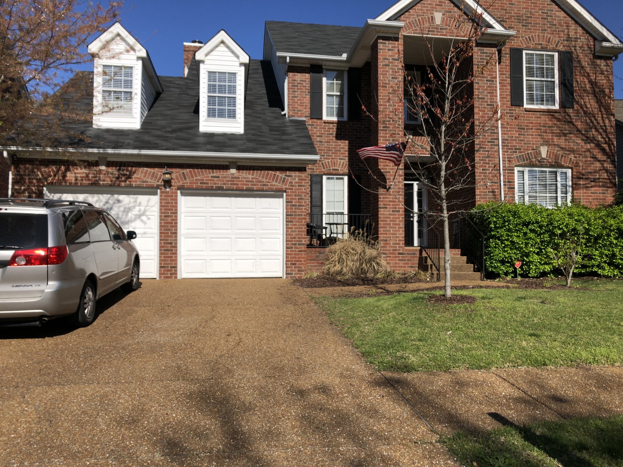 a couple of cars parked in front of a house