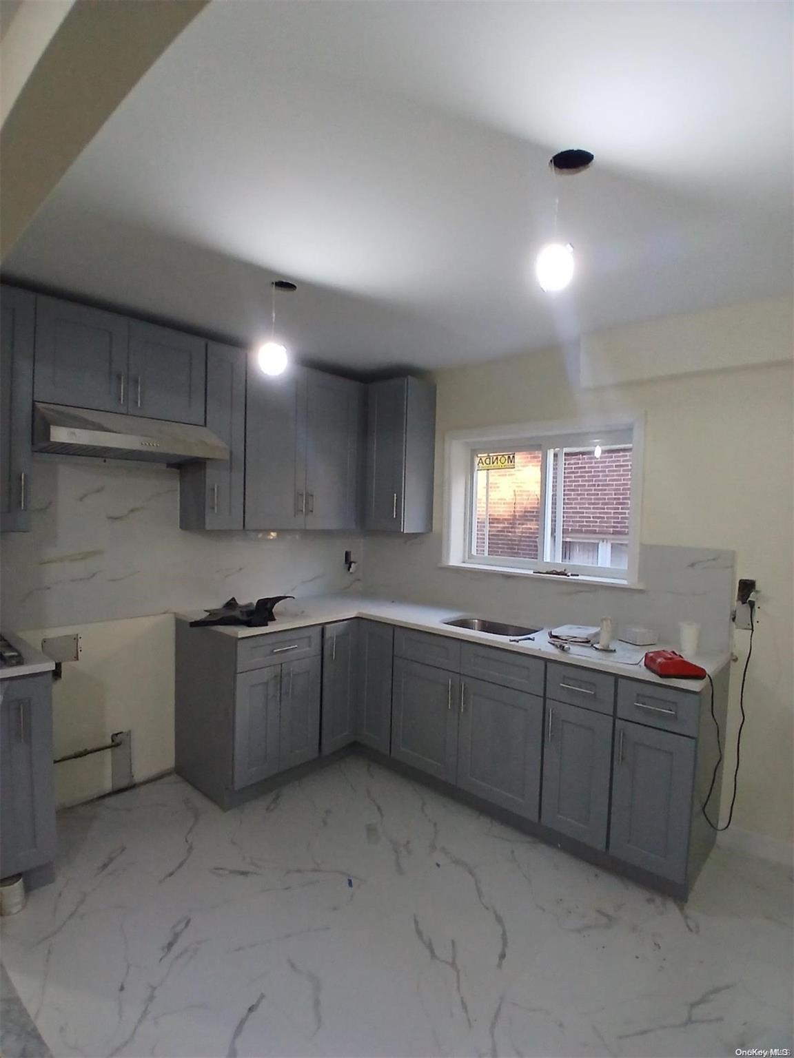 a kitchen with sink and cabinets