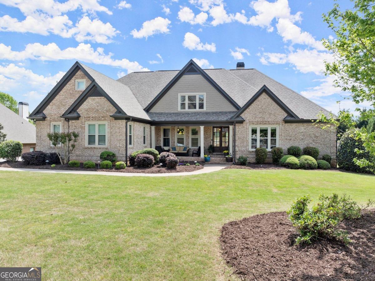 a front view of a house with swimming pool having outdoor seating