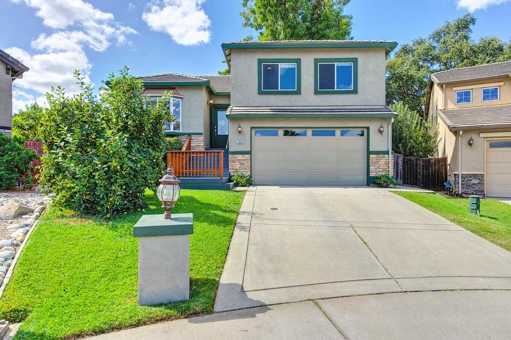 a front view of a house with a yard and garage