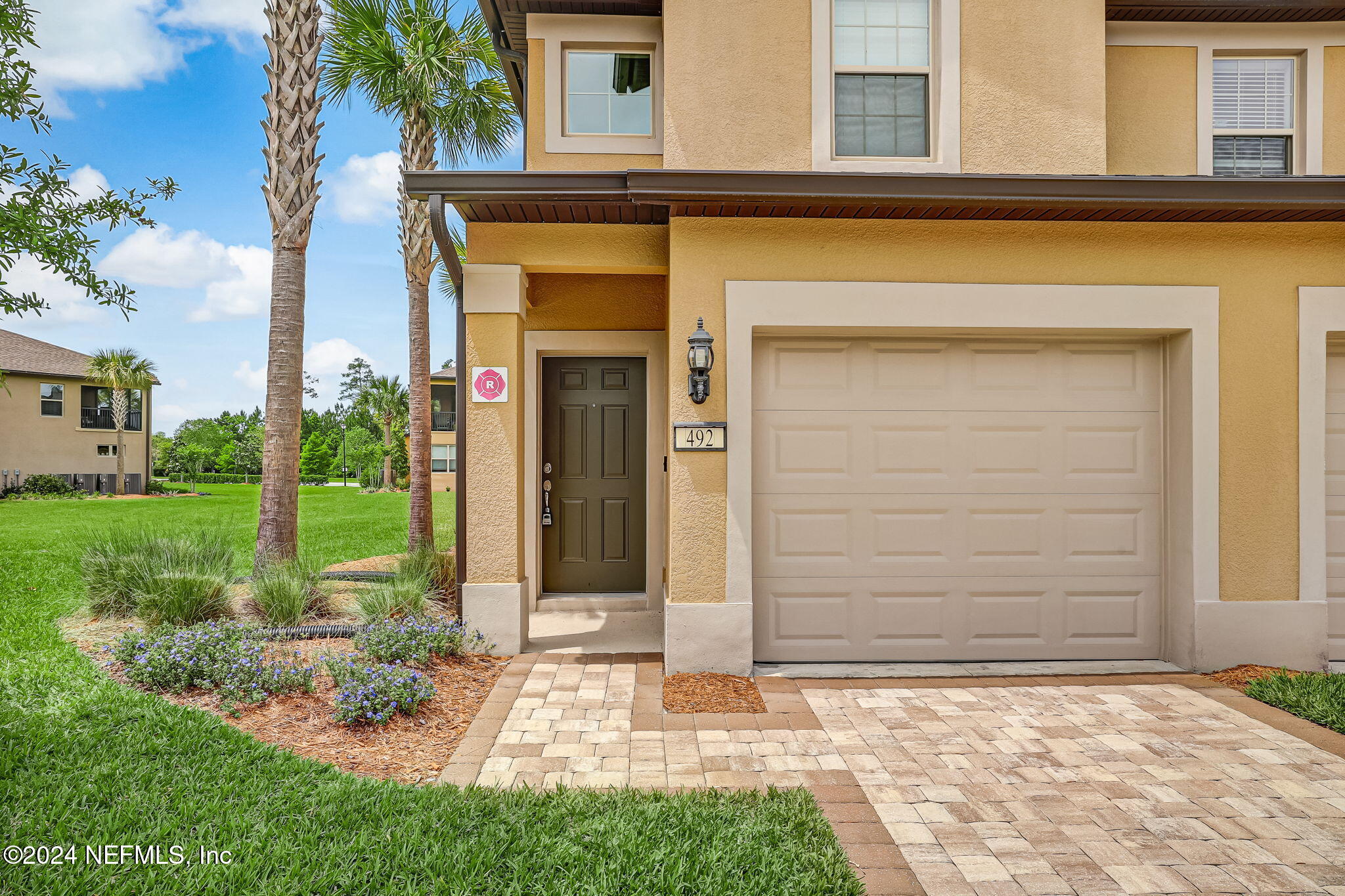 a front view of a house with a yard