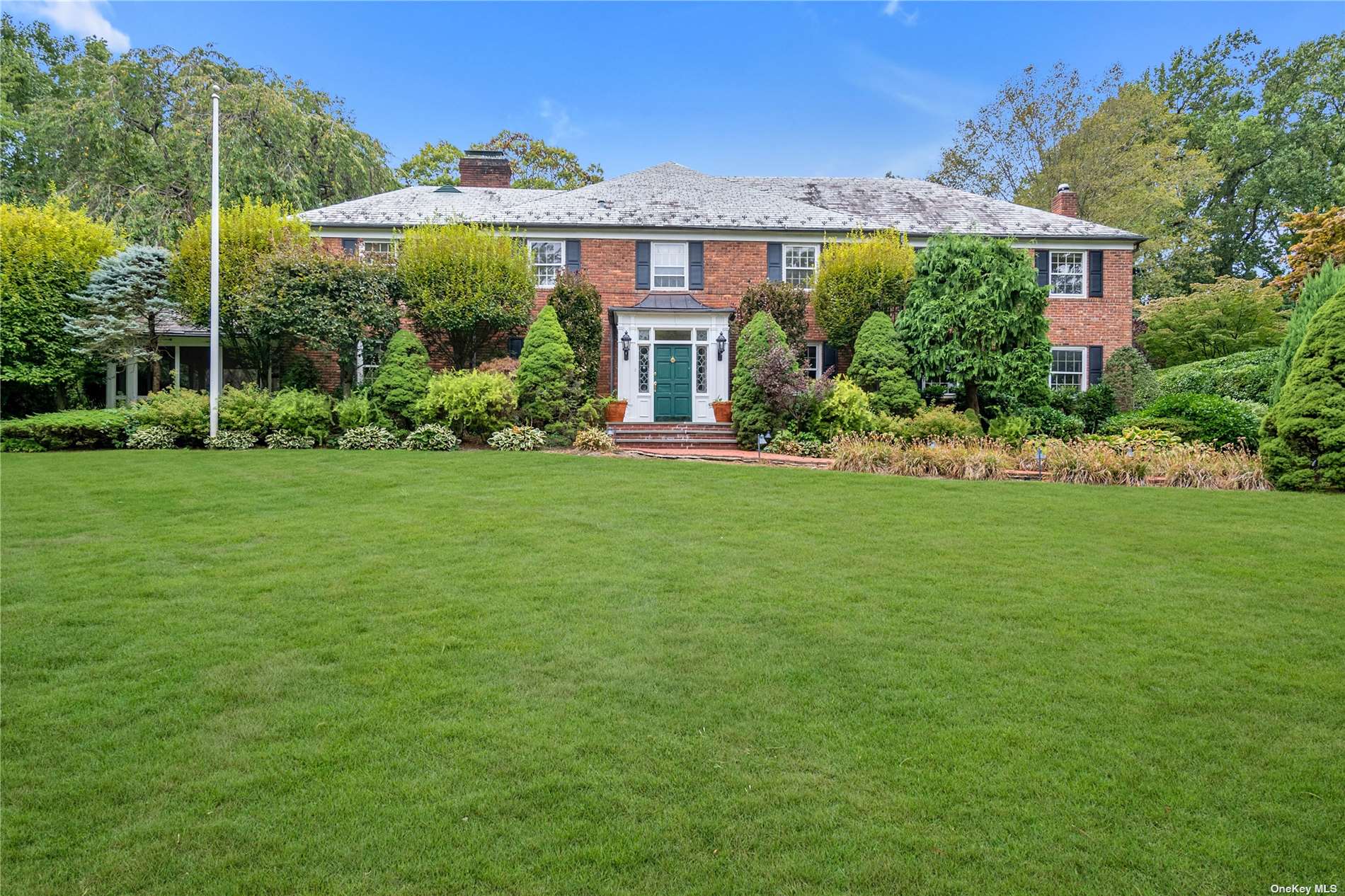 a front view of a house with a garden