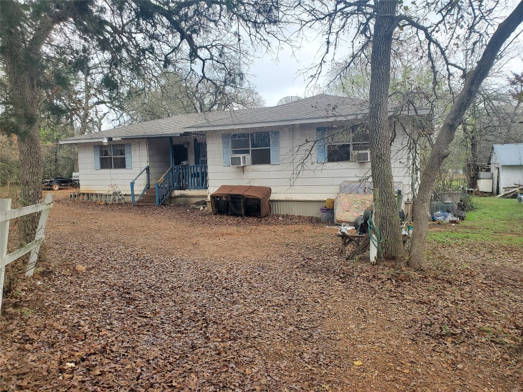 a front view of a house with a yard and seating space