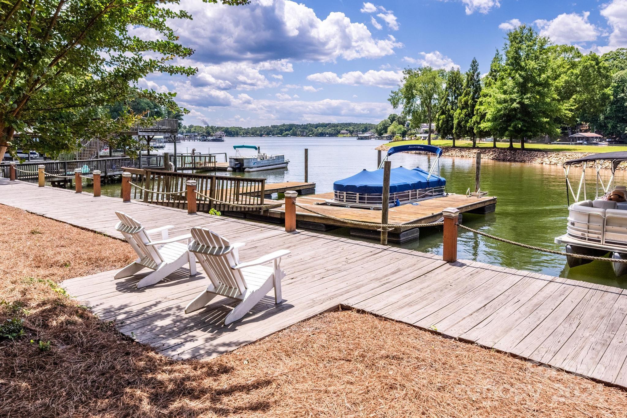 a view of a lake with tables and chairs