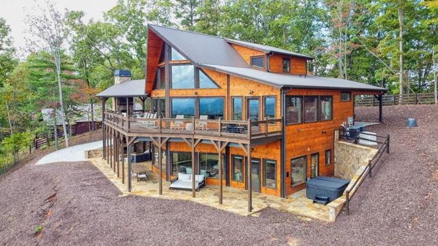 a view of a house with backyard and sitting area