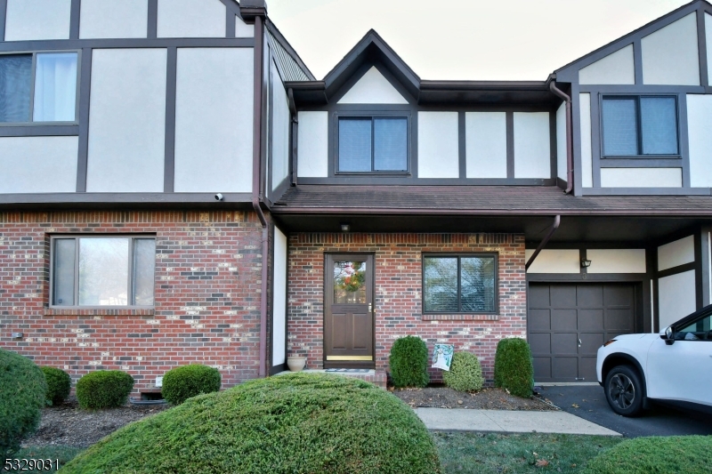 a view of house with backyard space and balcony